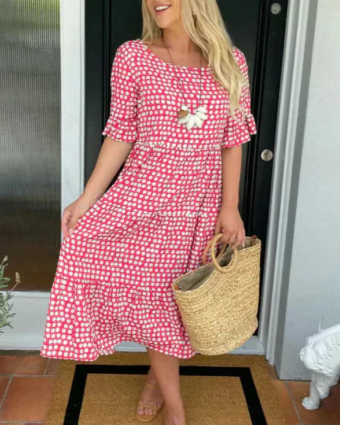 Red dot-print summer dress with white flower applique and tiered skirt