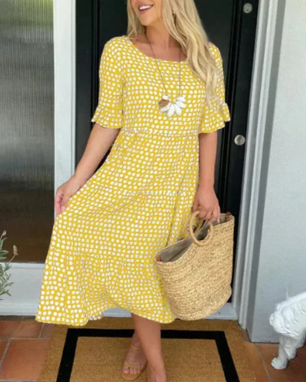 Yellow dot-print summer dress with white flower applique and tiered skirt
