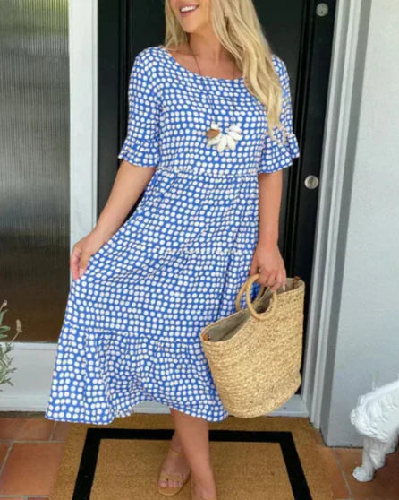 Blue and white polka-dot knee-length dress with short sleeves and flower applique