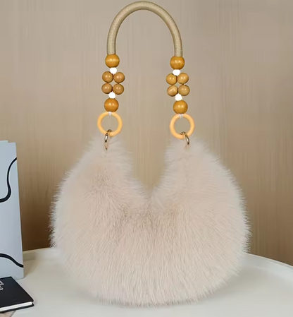 Maine faux hobo handbag with white faux-fur body and tan-beaded handles with rings