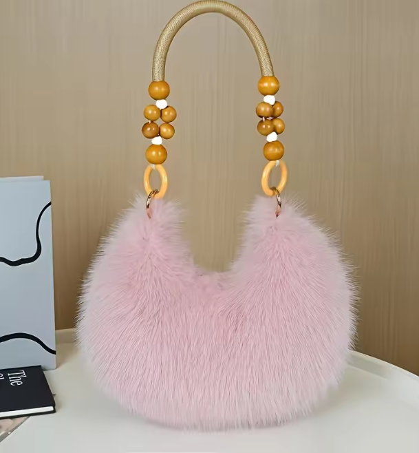 Maine faux hobo handbag with pink faux-fur body and tan-beaded handles with rings