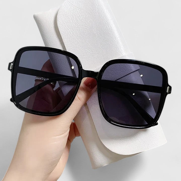 Black square sunglasses with dark tinted lenses and metal hinges