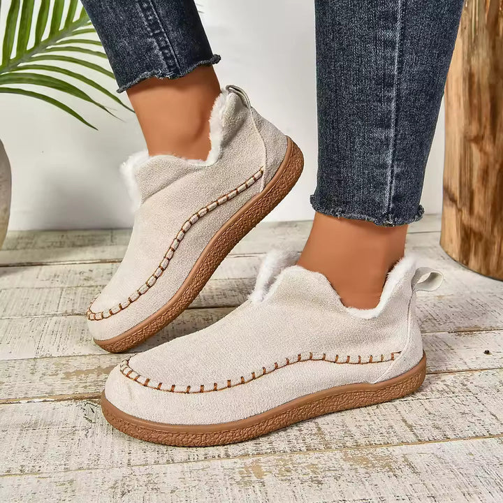 Beige orthopedic slip-on slippers with fuzzy collar and stitched moccasin trim