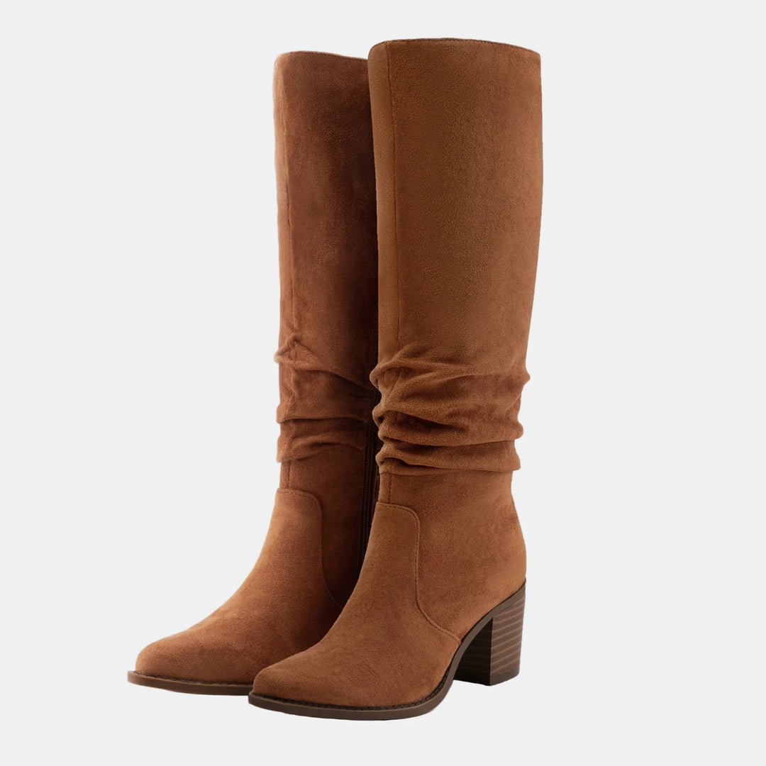 Tan suede knee-high boots with ruched front, side zip, and block heel