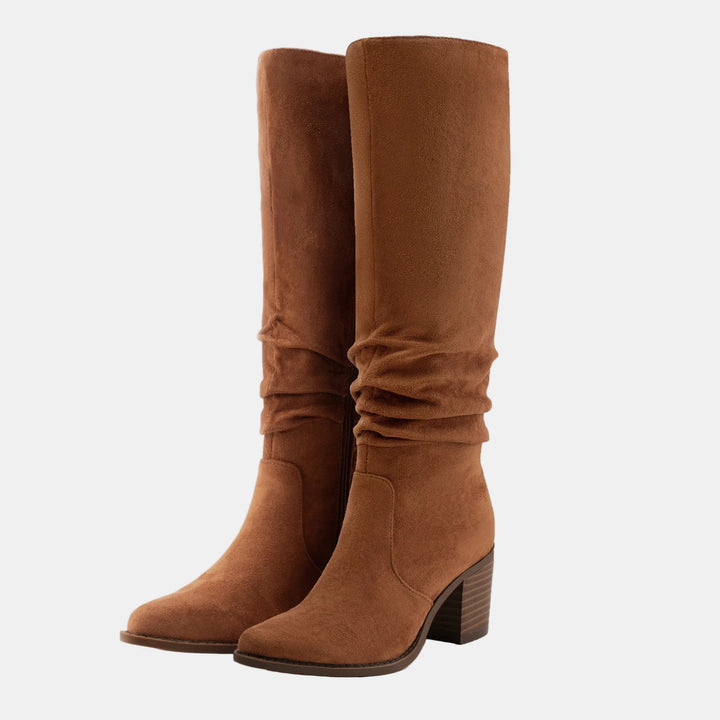 Tan suede knee-high boots with ruched front, side zip, and block heel