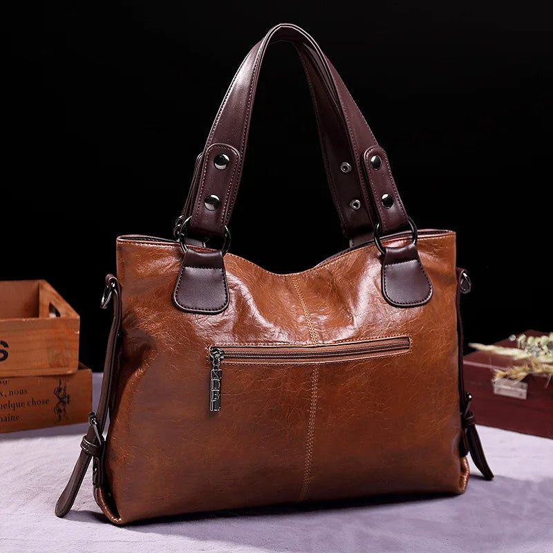 Brown soft leather tote bag with front zip pocket and double handles