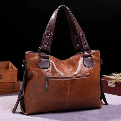 Brown soft leather tote bag with front zip pocket and double handles