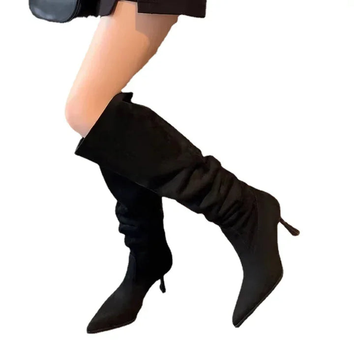 Black pointed-toe heeled cowboy boots, tall slouchy shaft, pointed toe, slim heel