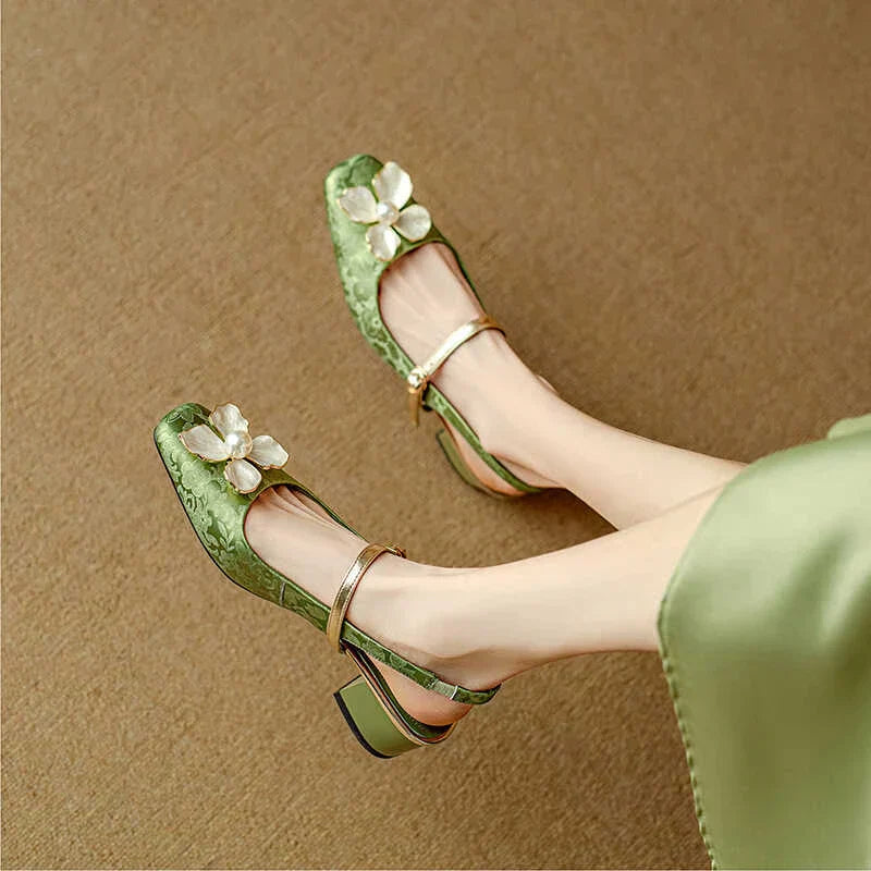 Green elegant pumps with ankle strap, low block heel, and white flower embellishments