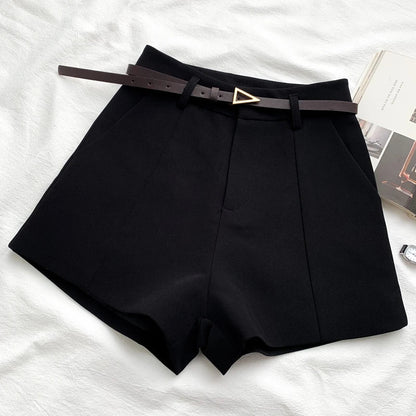 Black high-waist shorts with front crease and faux leather belt with gold buckle