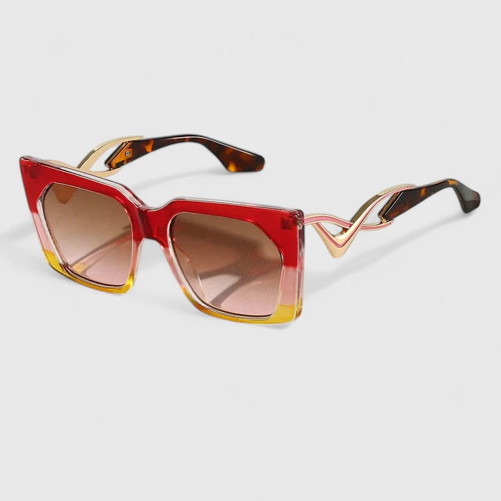 Cat-eye sunglasses with red frame, warm tortoise edges, and pink-tan lenses