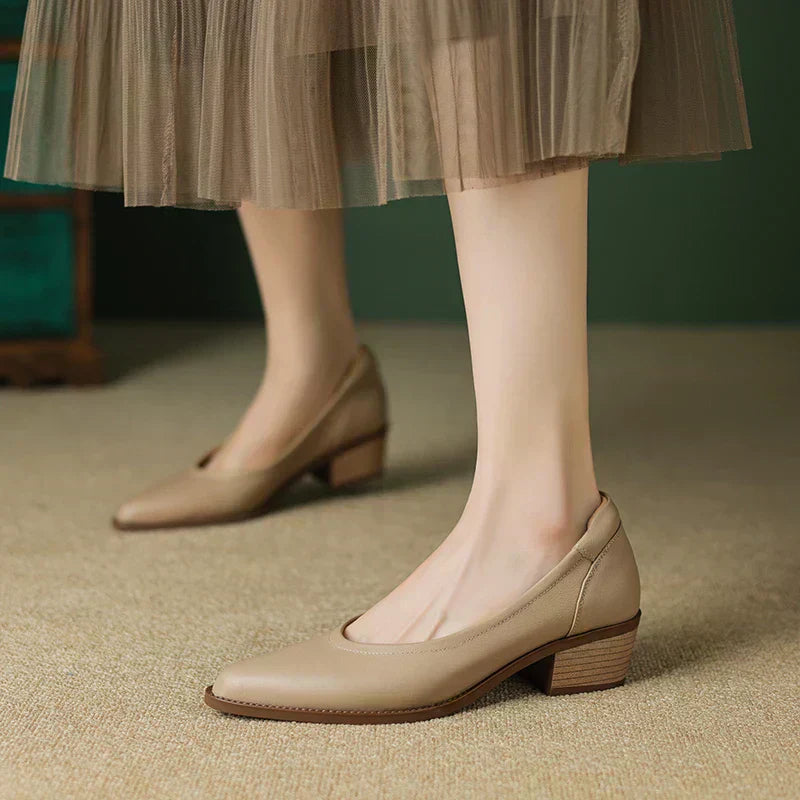 Apricot mid heeled shoes with pointed toe and low block heel, front view on foot