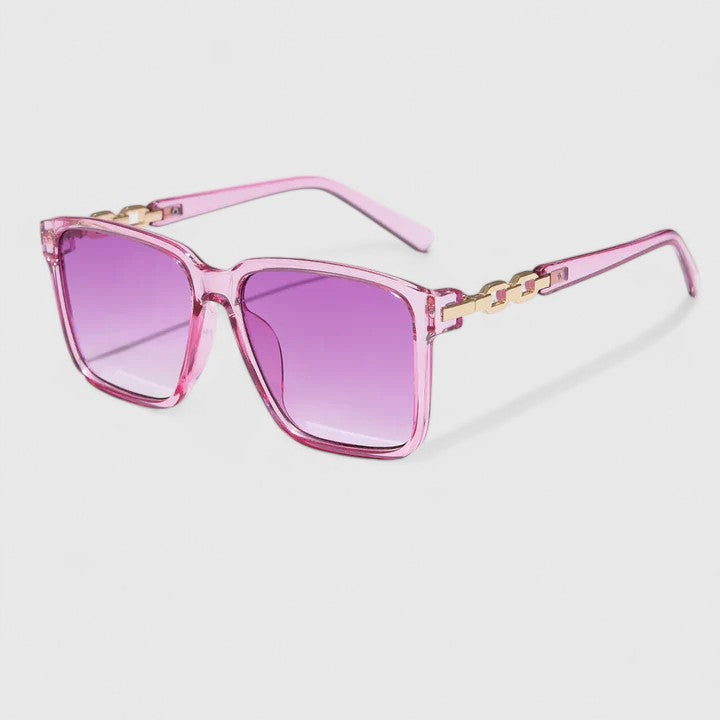 Square pink sunglasses with purple gradient lenses and gold chain hinge detail