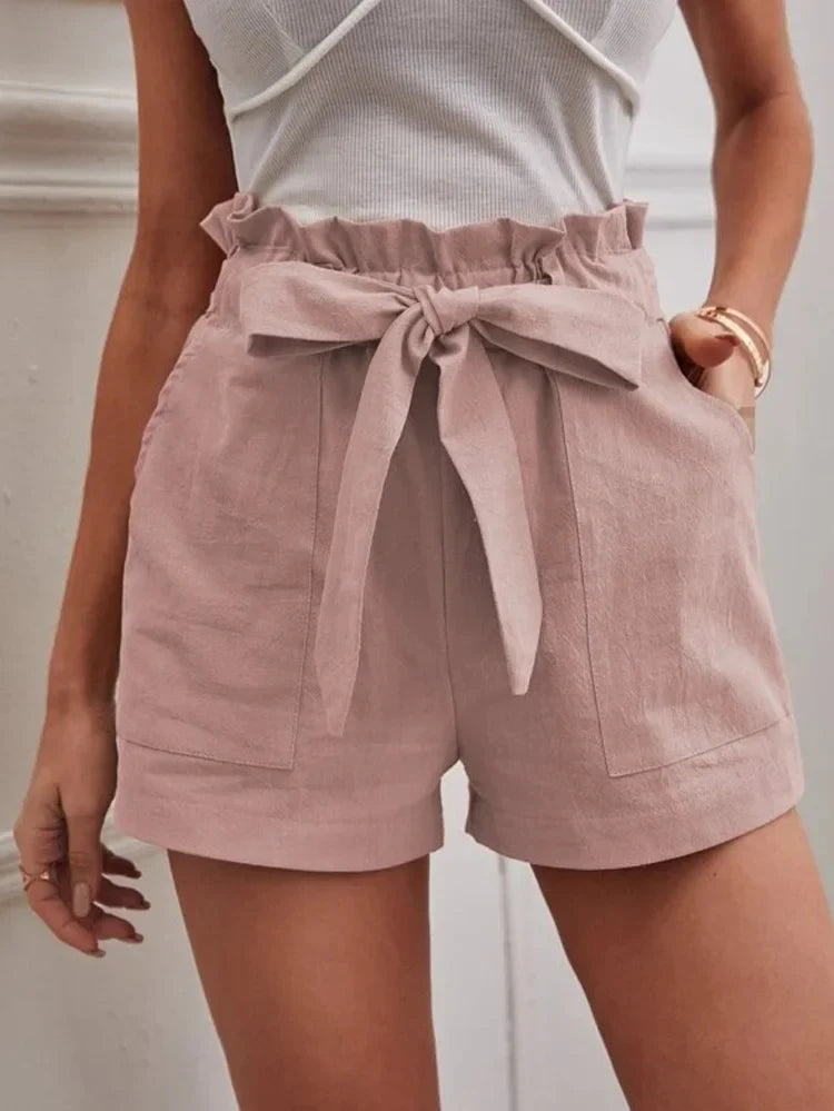 Blush pink paper-bag shorts with bow tie, ruffled elastic waist, side pockets.