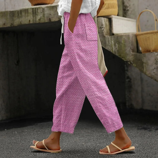 Pink patterned summer pants with relaxed fit and cropped ankle length, side pockets.
