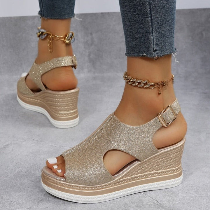 Gold glitter wedge sandals with ankle strap and chain ornament, peep-toe cutouts
