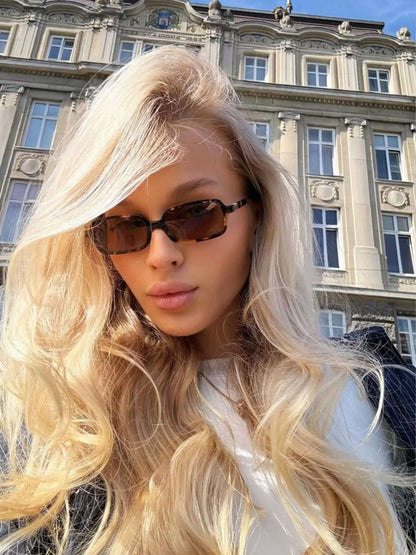 Square sunglasses with dark lenses on a person outdoors