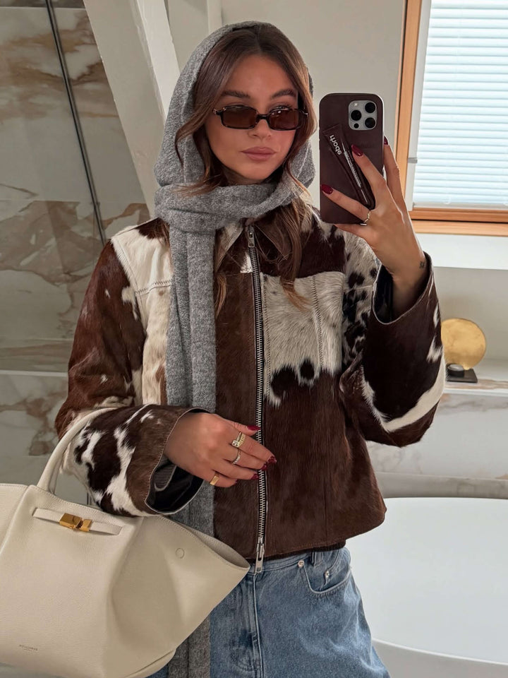 Dark square sunglasses with dark lenses, worn by a person indoors