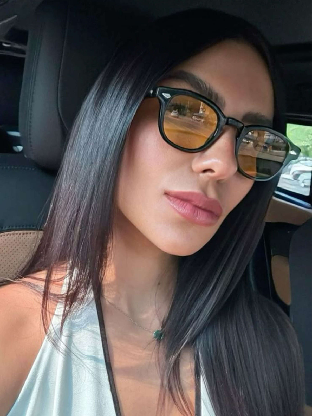 Black sunglasses with amber mirrored lenses and thick round frame