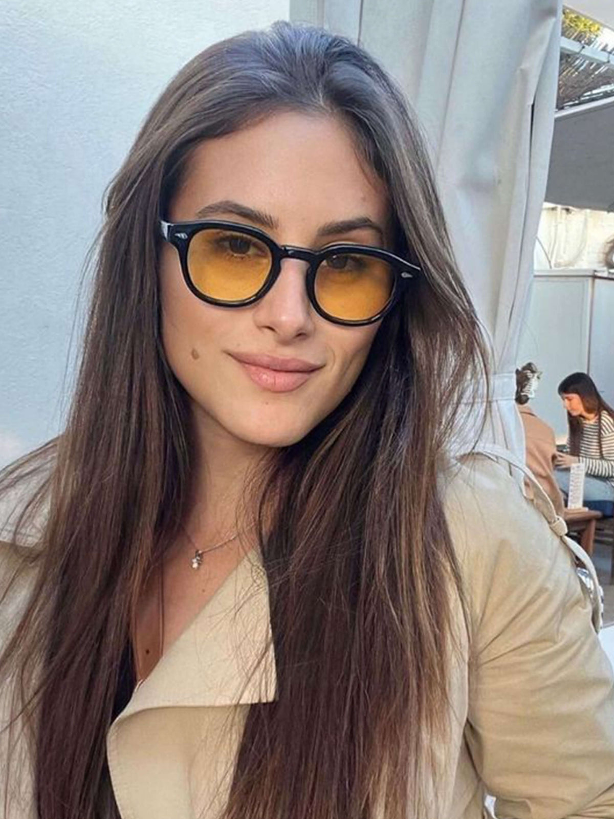 Black sunglasses with amber tinted lenses and round frame