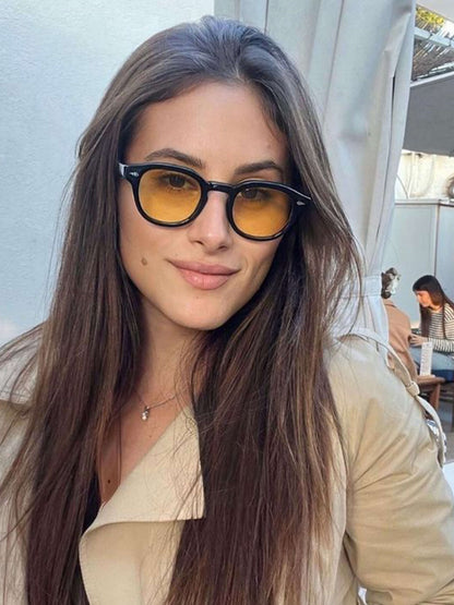 Black sunglasses with amber tinted lenses and round frame