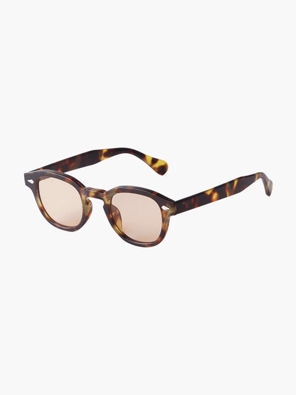 Tortoiseshell sunglasses with pale beige tinted lenses and slim dark arms