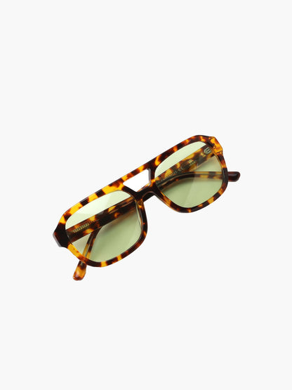 Tortoiseshell sunglasses with green-tinted lenses and slim rectangular frames