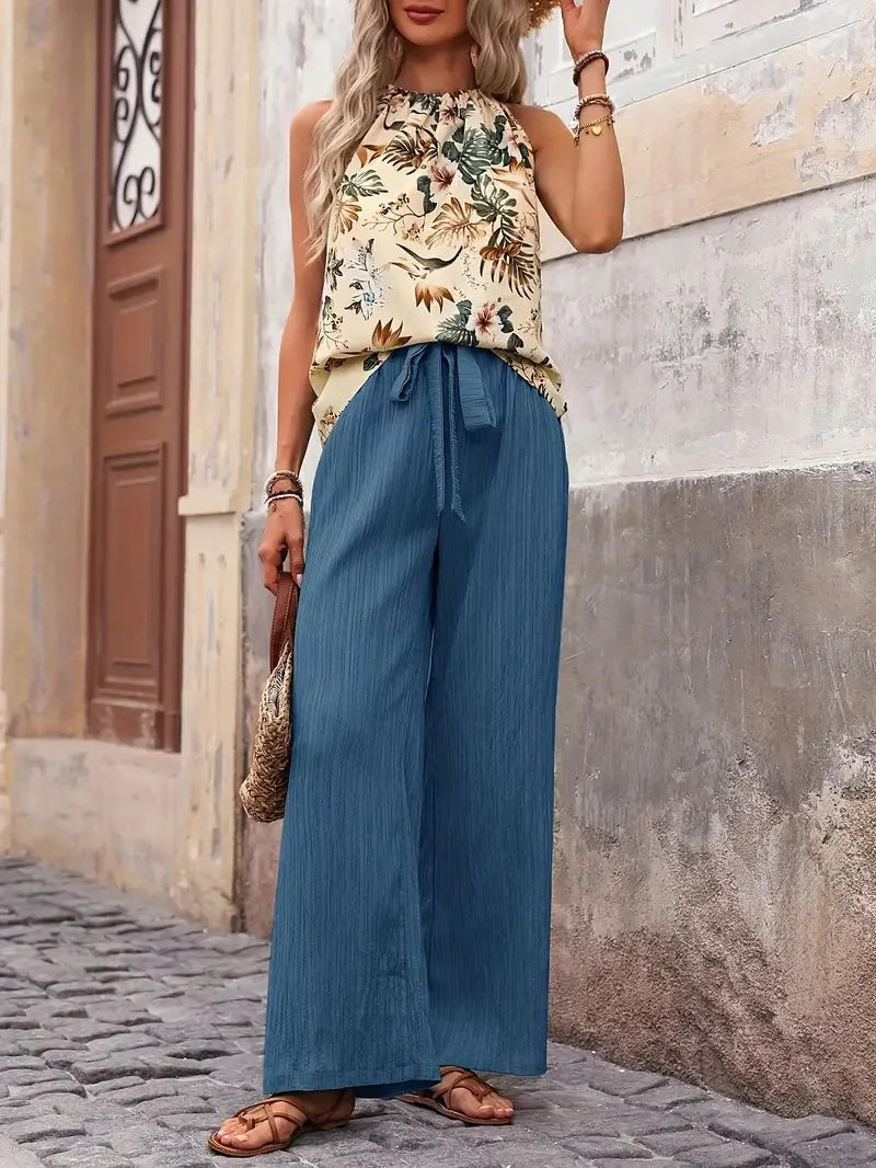 Two-piece set with sleeveless floral blouse and blue wide-leg drawstring pants