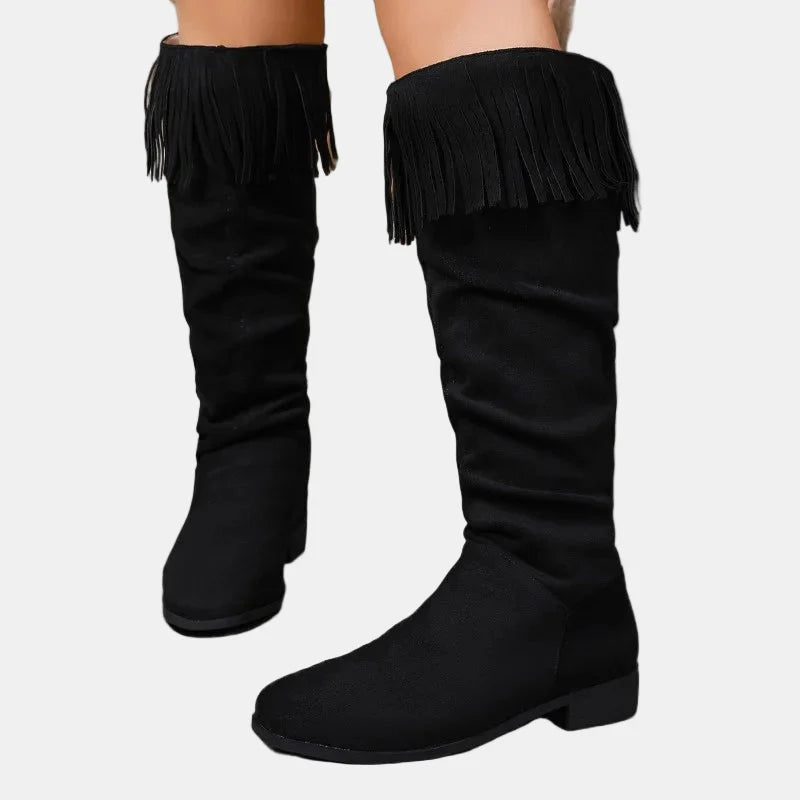 Black knee-high tassel boots with ruched shaft and block heel.