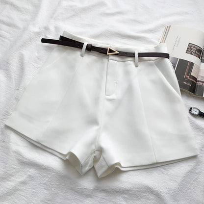 White high-waist shorts with front crease and faux leather belt with gold buckle