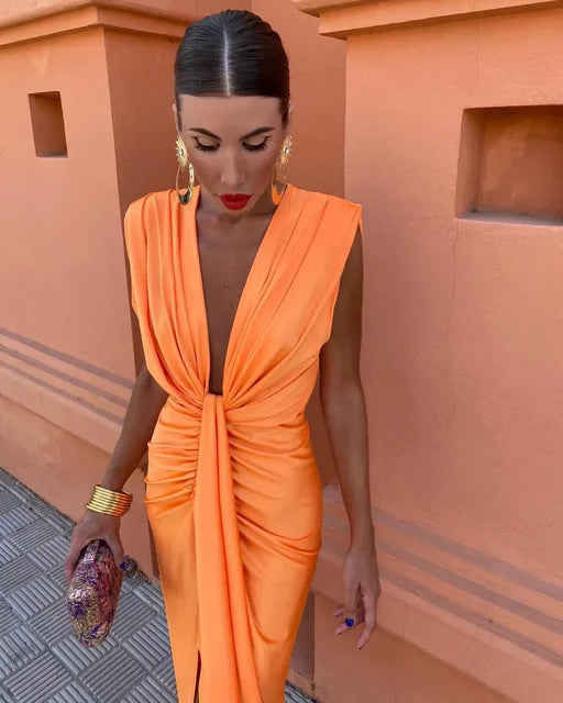 Pleated wrap dress in orange with sleeveless draped knot detail