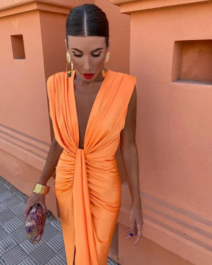 Pleated wrap dress in orange with sleeveless draped knot detail