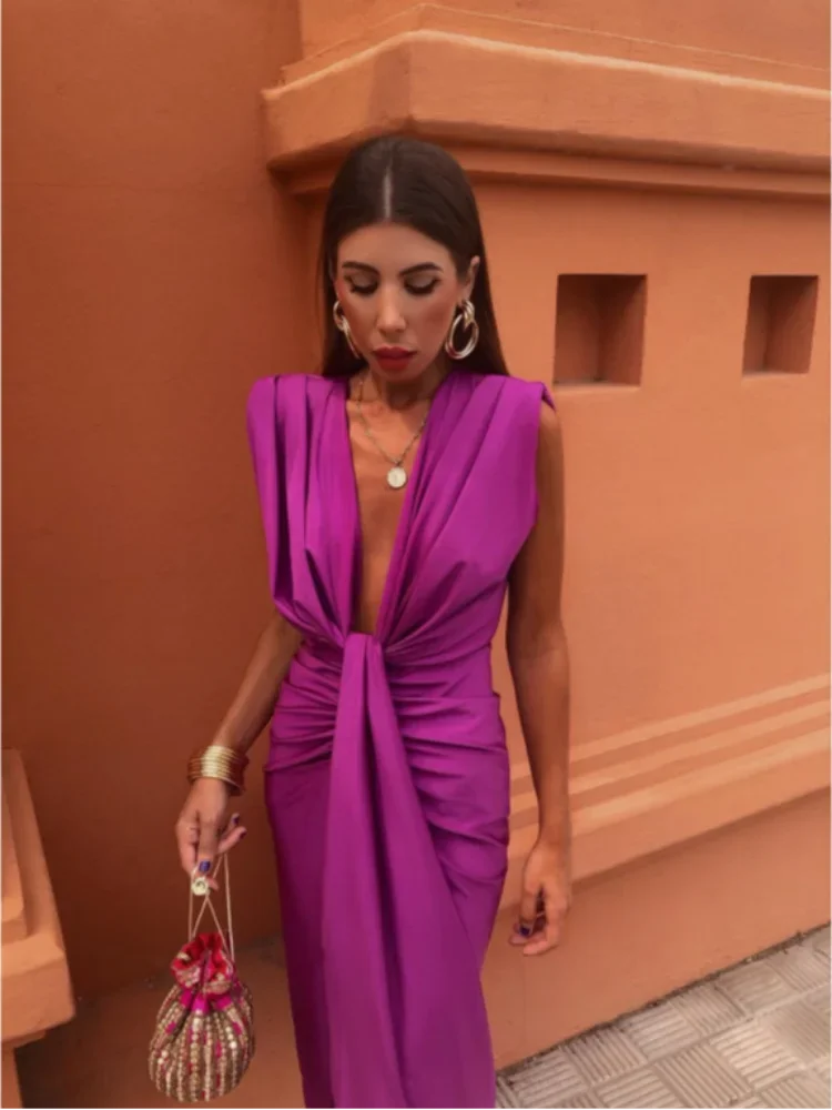 Pleated wrap dress in fuchsia with sleeveless deep V neckline and waist tie