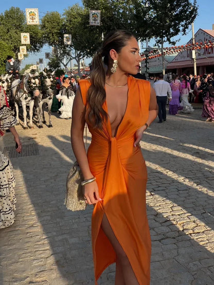 Pleated wrap dress in orange with deep V front and side slit