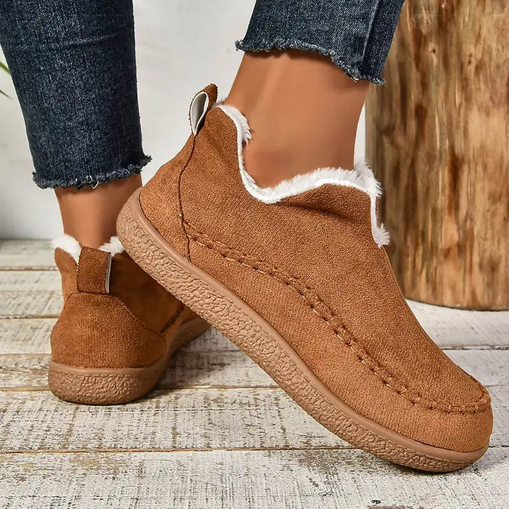Brown orthopedic slip-on slippers with faux-fur lining and stitched seam trim