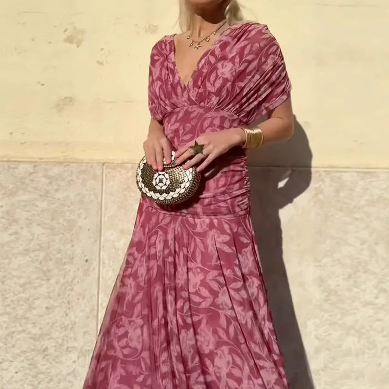 Pink and magenta floral dress with V-neck, short sleeves, and ruched bodice