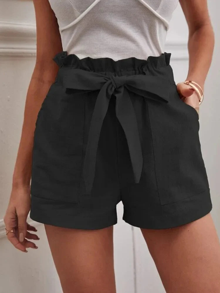 Black paper-bag shorts with bow tie, ruffled elastic waist, side pockets.