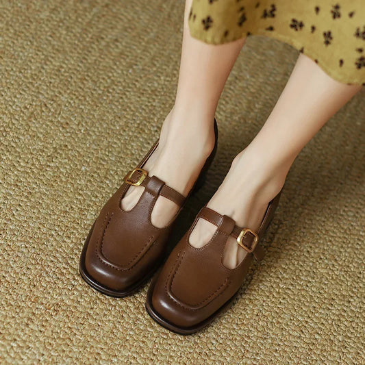 Brown T-strap loafers with buckle strap and stitched moc-style toe