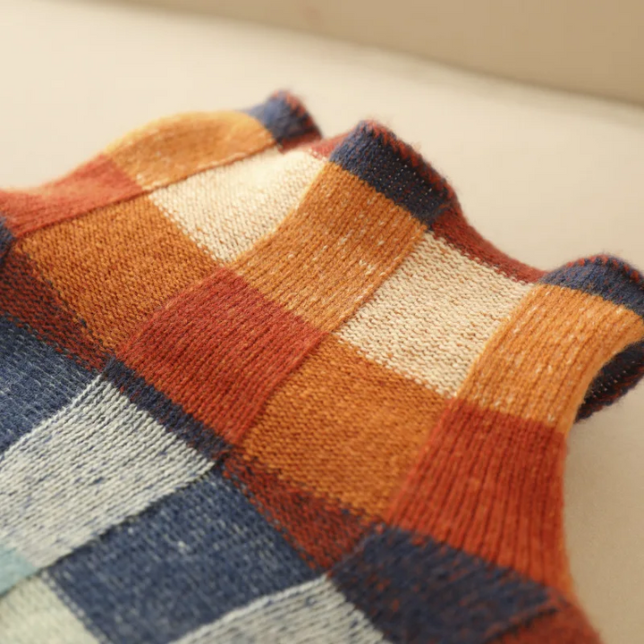 Plaid knit sweater hem and lower body; ribbed texture with multicolor square pattern.