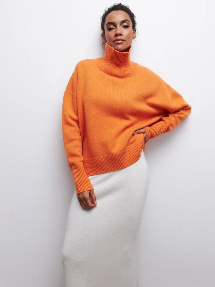 Orange turtleneck sweater with long sleeves and ribbed cuffs