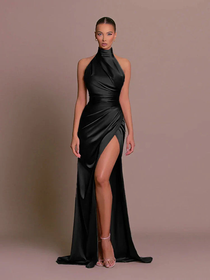 Black satin side-slit maxi dress, halter neck, sleeveless with draped wrap front.
