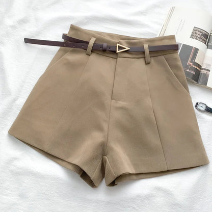 Beige high-waist shorts with front crease and matching belt with gold buckle