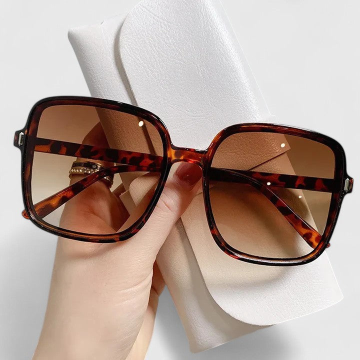 Tortoise square sunglasses with amber tinted lenses and metal hinges