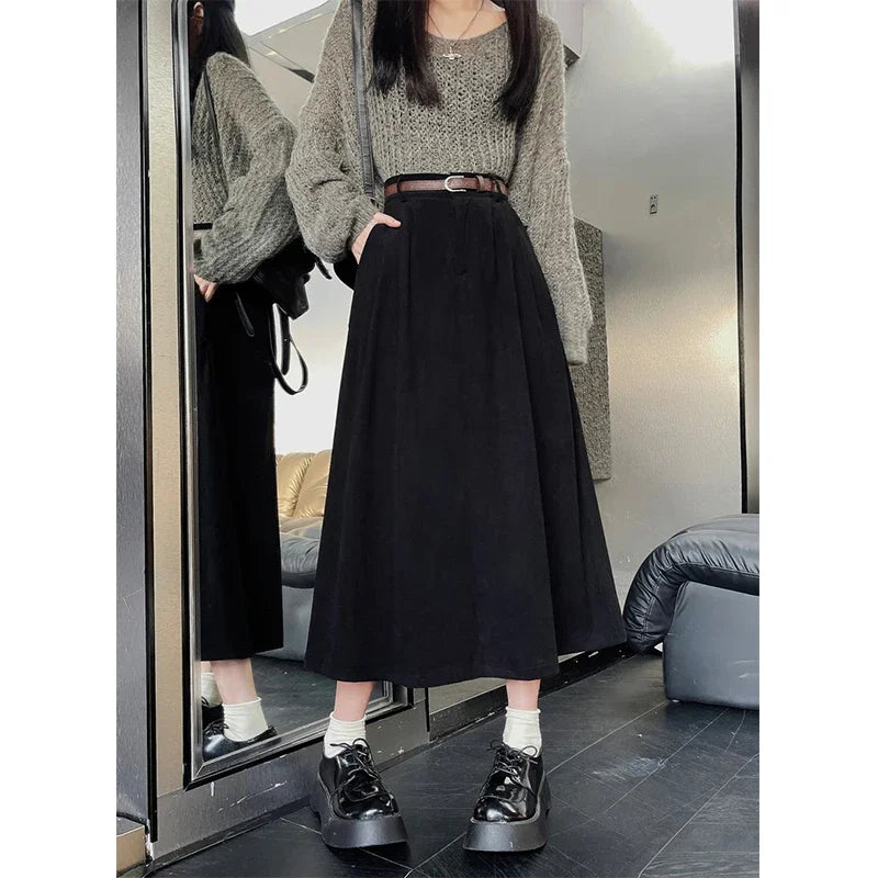 Black corduroy midi skirt with wide belt and gathered waistband pleats