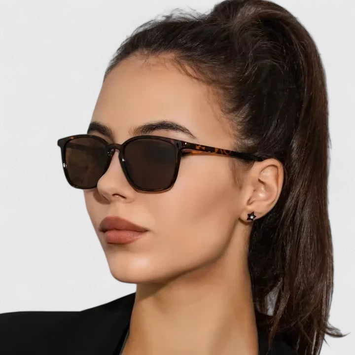 Sophisticated sunglasses on model, tortoiseshell frame with dark lenses