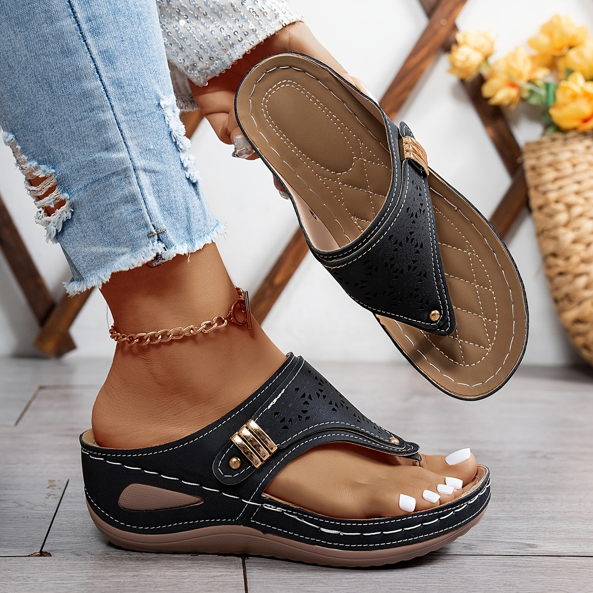 Black orthopedic sandals with perforated upper and double buckle toe strap