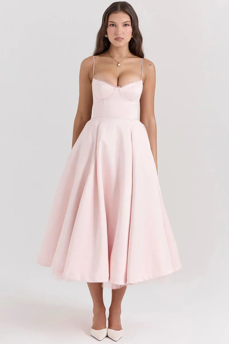 Blush pink midi dress with spaghetti straps, sweetheart bodice, and soft pleated skirt