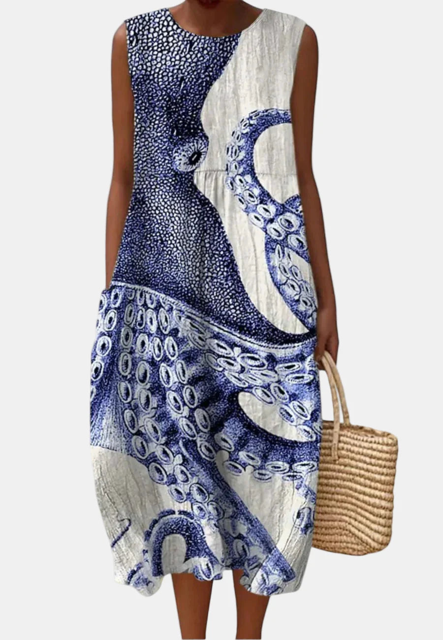 Sleeveless ocean blue and white patterned dress with round neck and draped front panel