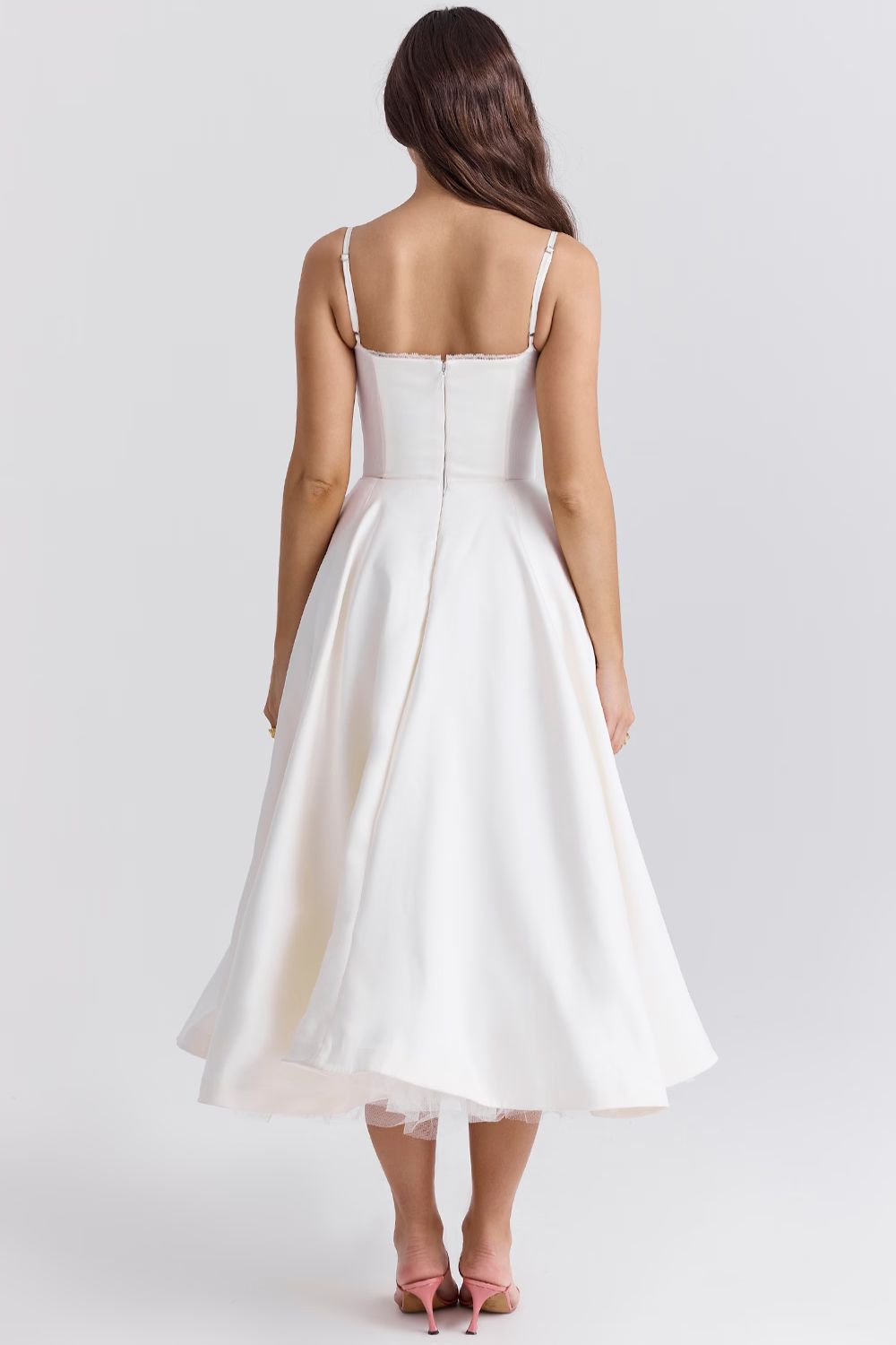 White satin dress with spaghetti straps, fitted back, and layered tulle midi hem