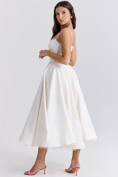 White satin midi dress with spaghetti straps and layered tulle skirt, side view